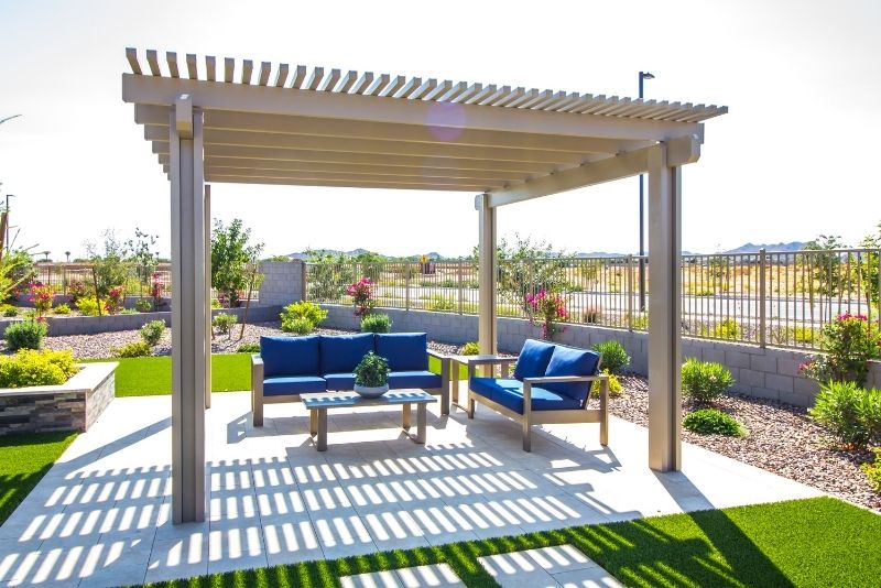 Pergola attached to a home, providing a shaded outdoor seating area