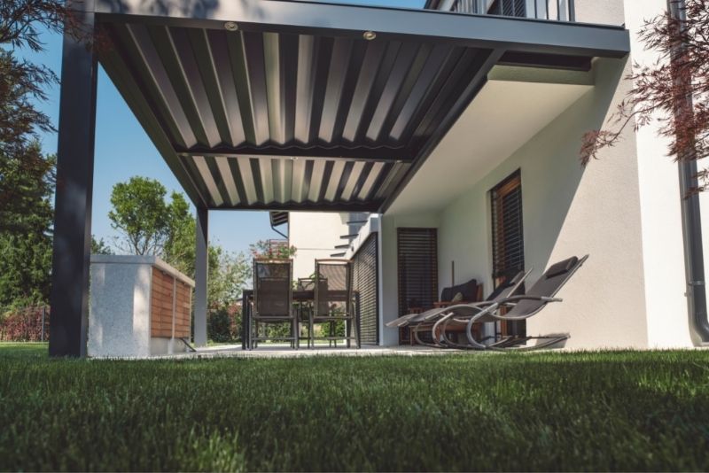 Louvred pergola over an outdoor dining and lounge area