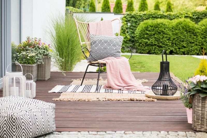 Patio deck styled with outdoor furniture and potted plants